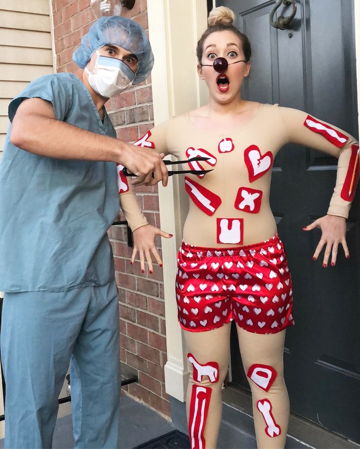 a man and woman dressed up in costumes with masks on their faces, holding scissors