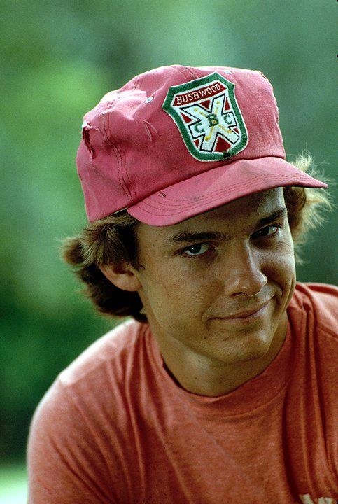 a young man wearing a red hat and looking at the camera with an intense look on his face