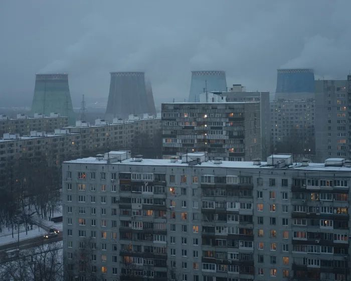 the city skyline is covered in snow and lit up by buildings with lights on them