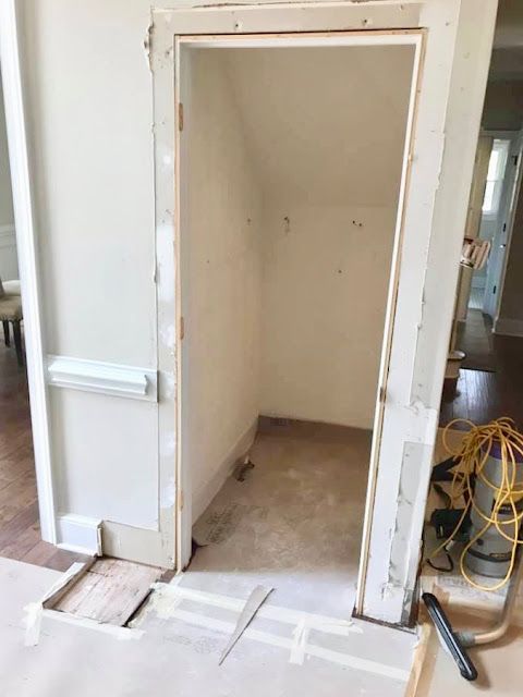 an open door is in the middle of a room with unfinished walls and flooring