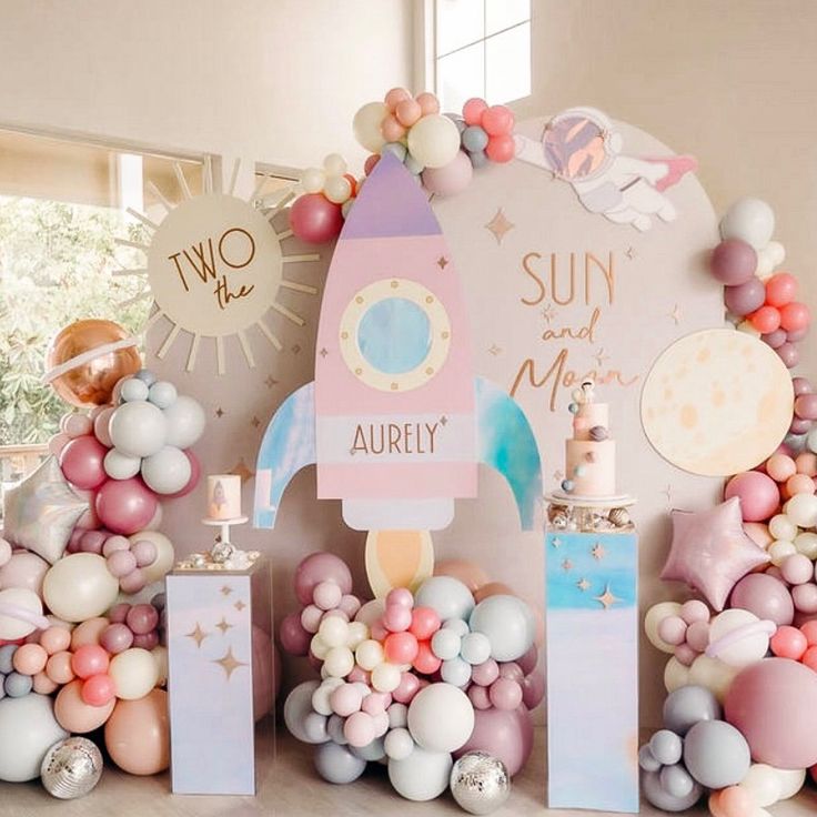 a room decorated with balloons and decorations for a baby's first birthday or other celebration