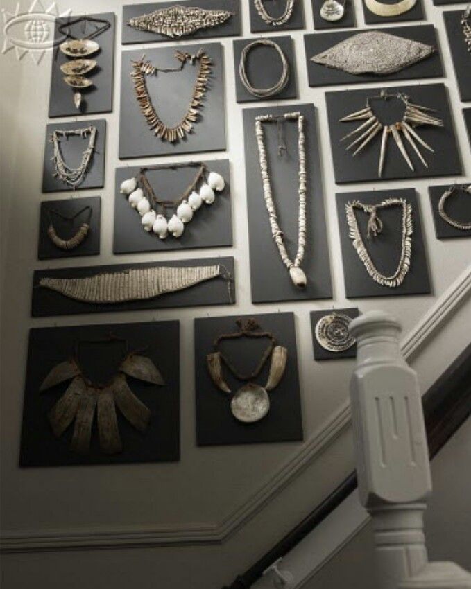 there are many different necklaces on the wall