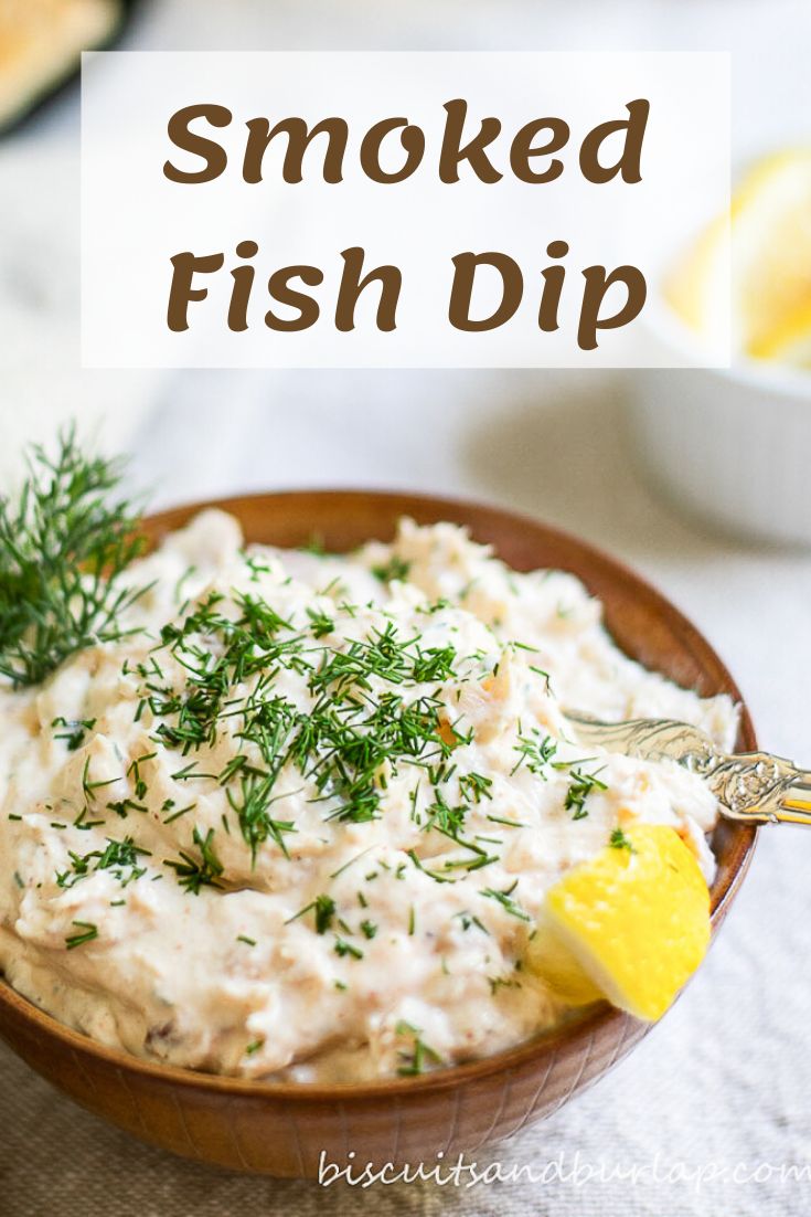 a wooden bowl filled with mashed fish dip