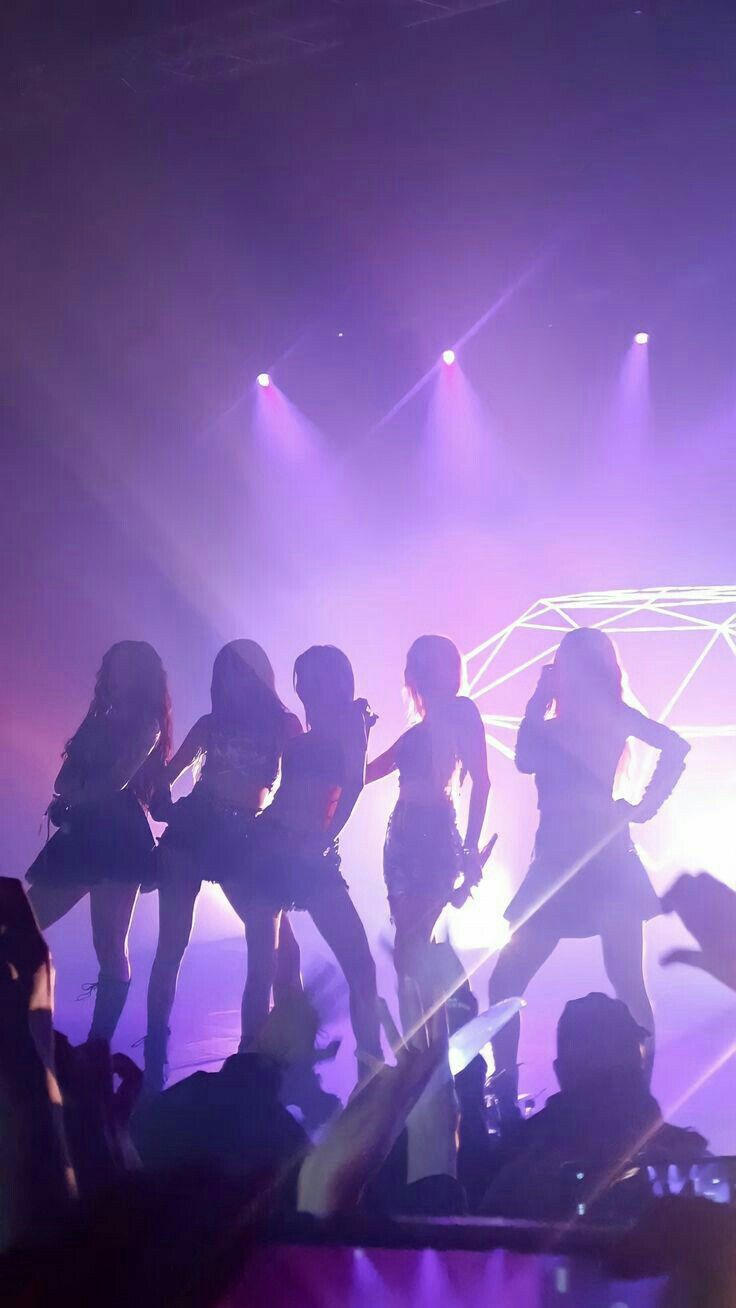 the girls are performing on stage in front of an audience