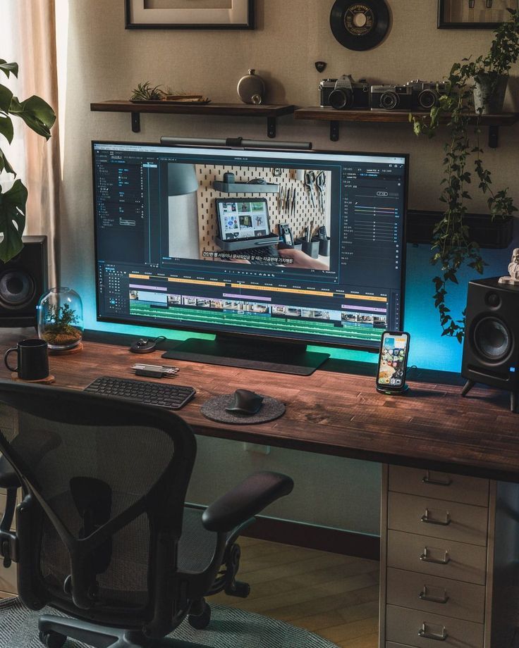 a computer monitor sitting on top of a wooden desk