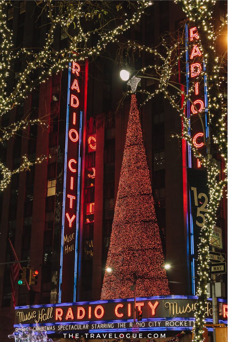 the radio city christmas tree is lit up at night