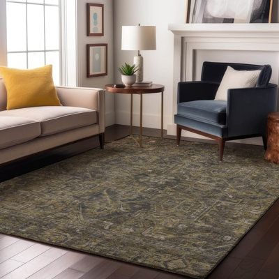 a living room with two couches and a rug on the floor in front of a fireplace