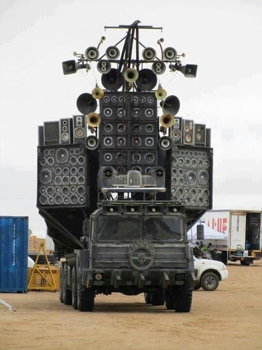 a large truck with speakers on top of it