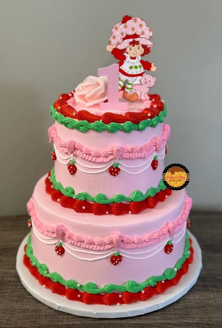 a three tiered cake decorated with pink and green icing