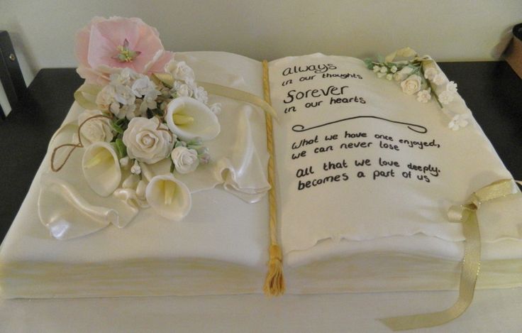 an open book decorated with flowers and writing on the pages is sitting on a table