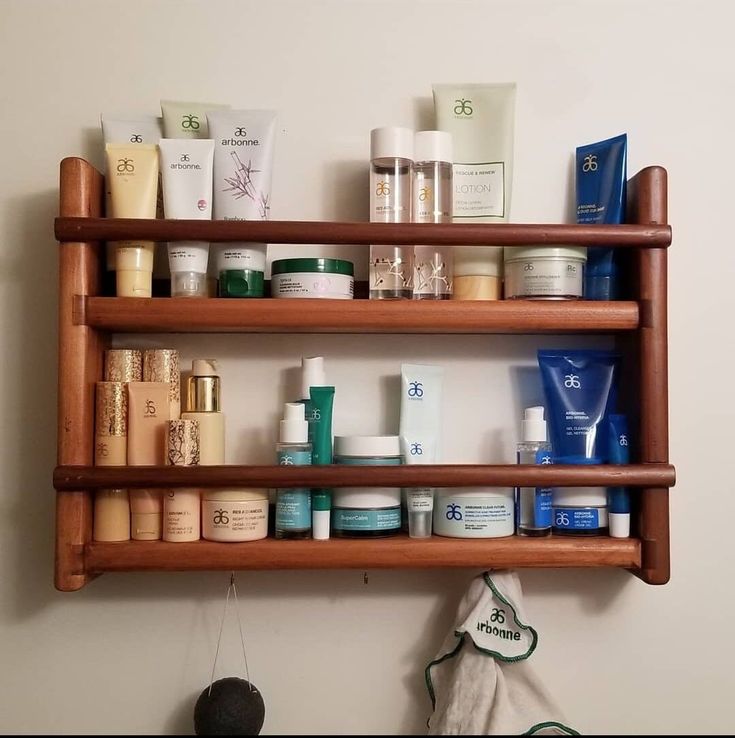 a wooden shelf filled with lots of different types of skin care products on top of it