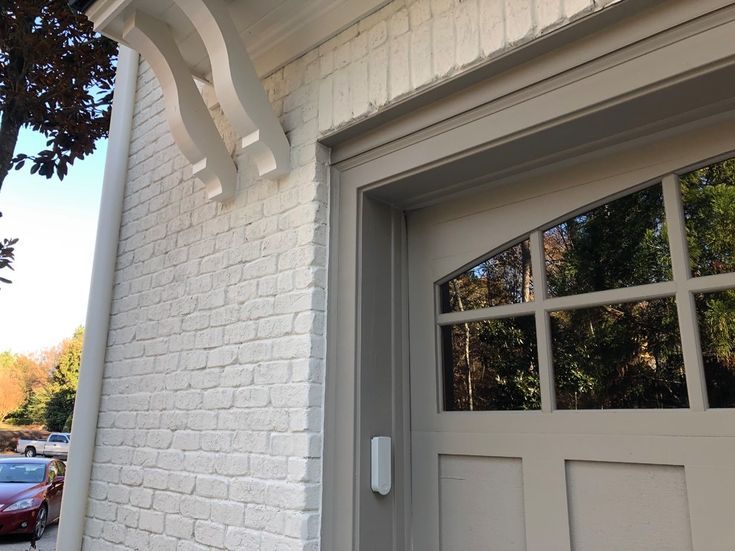 a white brick building with an arched window