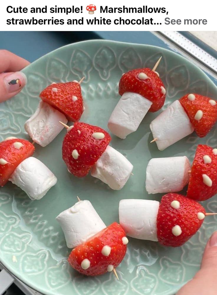 marshmallows and strawberries are arranged on a plate