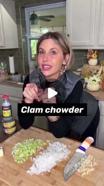 a woman standing in front of a cutting board with food on it and the words clam chowder