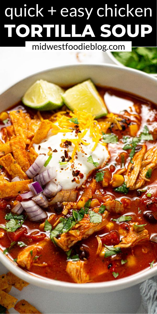 a white bowl filled with tortilla soup and garnished with sour cream