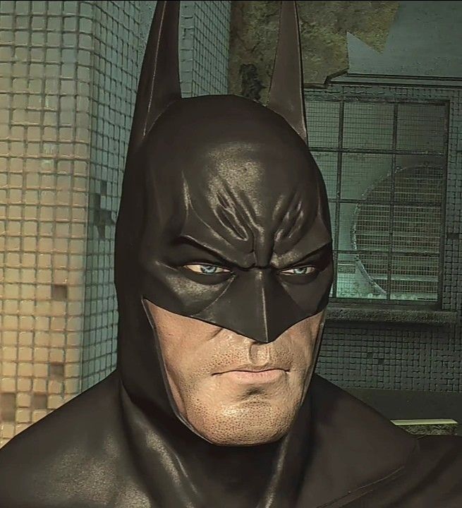 a man in a batman costume with blue eyes