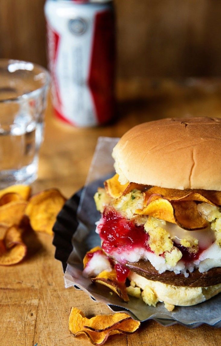 a burger with potato chips and ketchup on the side