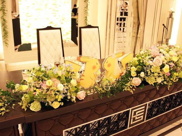 a long table with flowers and cards on it