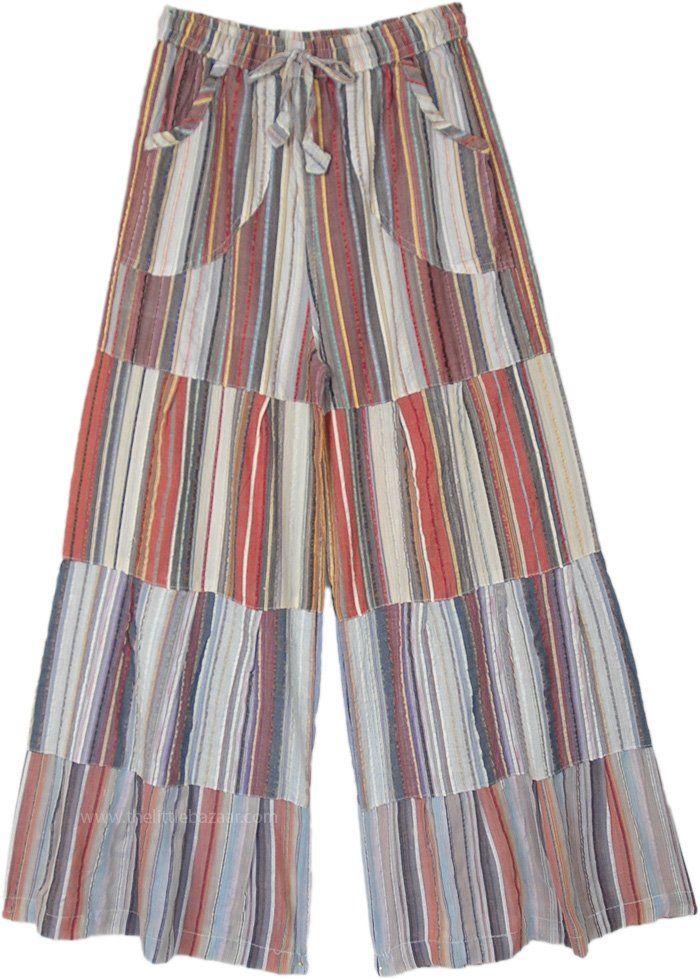 A pair of white-toned cotton wide-leg pants is the summer essential for the year.  With a drawstring waist, these pants ensure absolute comfort. #tlb #SplitSkirtsPants #Patchwork #Striped #fashiondeal #BohemianPants Beach Wide Leg Patchwork Pants, Beach Patchwork Wide Leg Pants, Spring Beach Pants With Patchwork, Spring Beach Patchwork Pants, Multicolor Cotton Wide Leg Pants With Pockets, Summer Wide Leg Cotton Pants With Pockets, Relaxed Fit Patchwork Bottoms For Summer, Summer Patchwork Wide-leg Bottoms, Summer Wide-leg Patchwork Pants