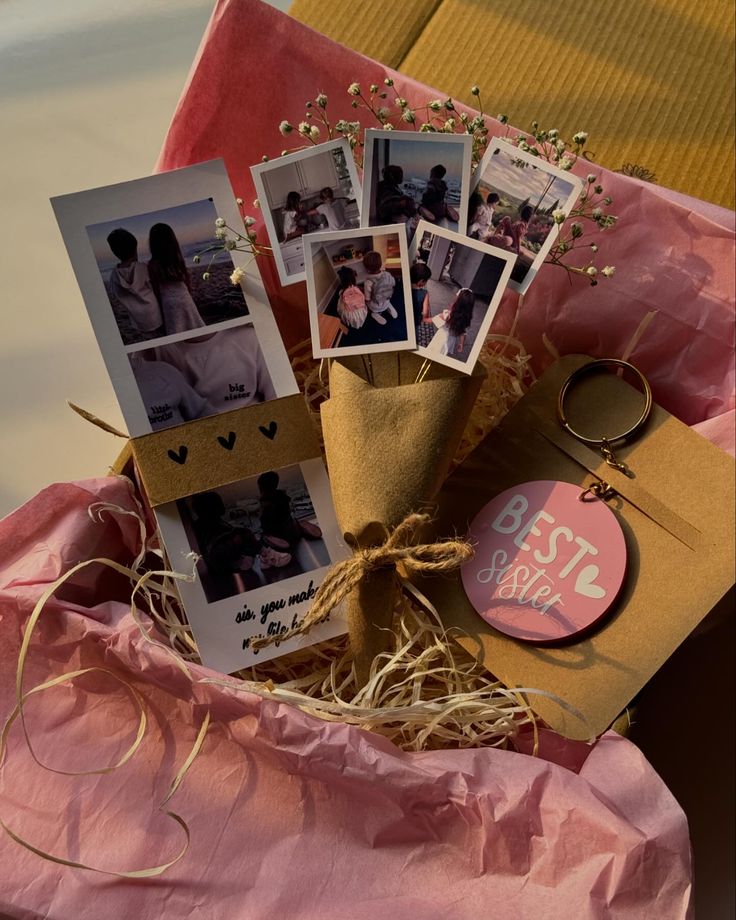 a bunch of pictures are placed on top of a pink cloth with some twine