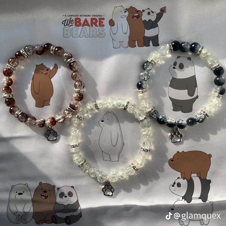 three bracelets with bear and panda charms on them, one is beaded in glass beads