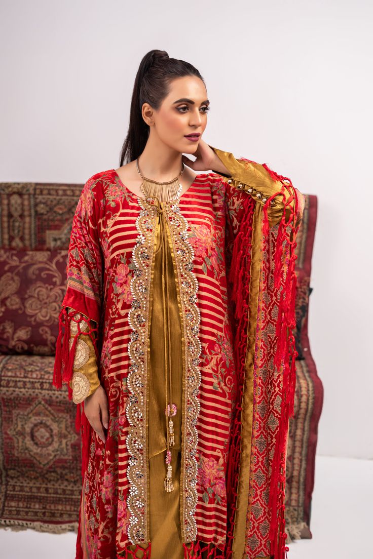 Discover luxury and elegance with our Red and Yellow Coat Shalwar Kameez. Made from plush materials, this front open poncho boasts intricate kundan work lace and resham tassels on each corner. The inner turmeric colored georgette silk shirt and pants add a touch of sophistication. Feel confident and stylish in this timeless piece. 3-Piece Suit Designer Gold Kaftan With Dabka Work, Festive Kaftan With Dupatta For Eid, Red Kaftan With Dupatta For Festivals, Festive Red Kaftan With Dupatta, Gold Resham Embroidered Kaftan For Diwali, Gold Kaftan With Resham Embroidery For Diwali, Gold Resham Embroidery Kaftan For Diwali, Unstitched Raw Silk Kaftan For Festive Occasions, Anarkali Kaftan With Dupatta For Festive Occasions