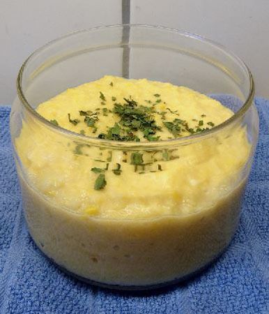 a glass bowl filled with food on top of a blue towel