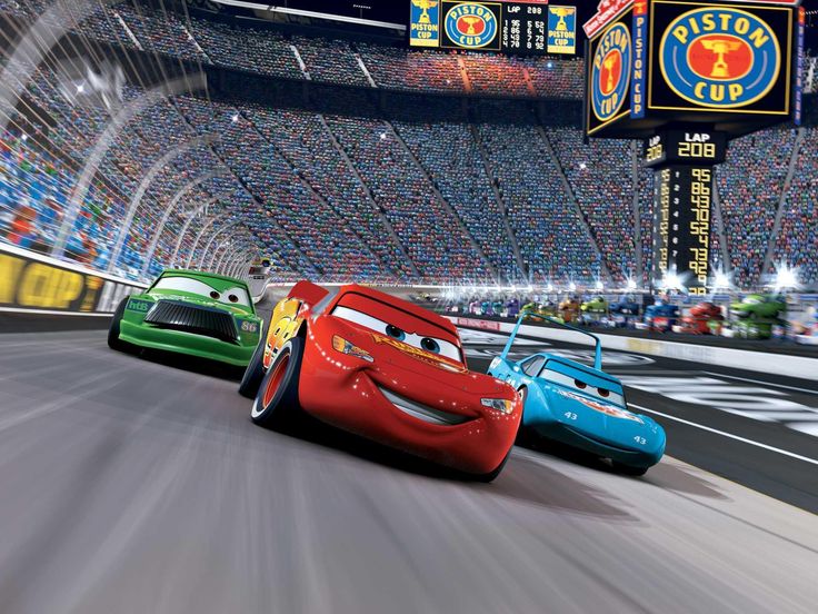 the cars are racing down the track in front of an audience at a movie theater