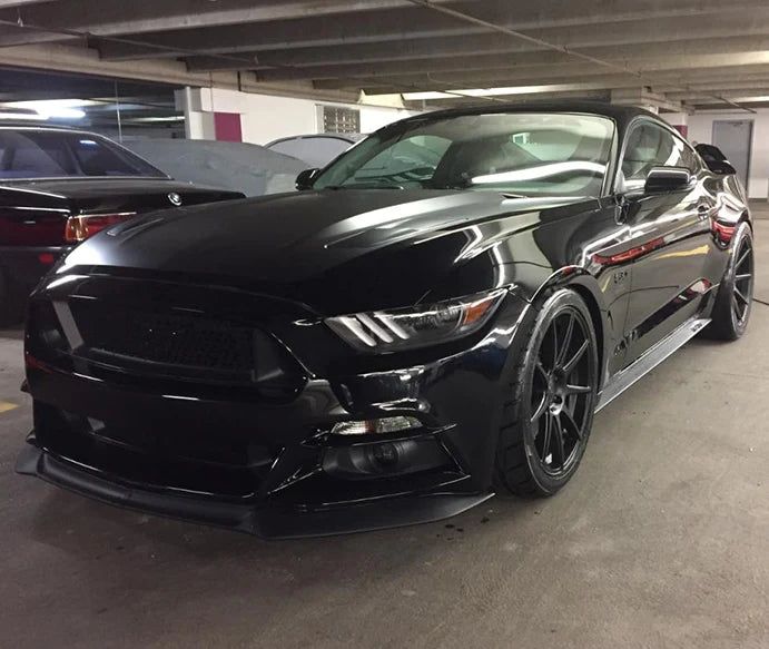 a black mustang parked in a parking garage