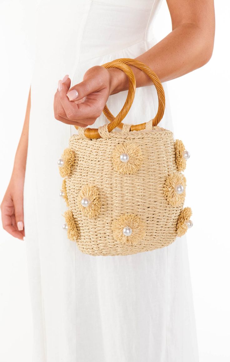 We are crazy about this gorgeous straw bag featuring beautiful raffia, pearl details & a circle handle. Take her anywhere, she's perfect for all occasions. Chic Woven Beach Bag With Round Handle, Chic Jute Straw Bag With Round Handle, Chic Spring Beach Bag With Round Handle, Natural Top Handle Straw Bag For Day Out, Chic Natural Straw Bag With Round Handle, Elegant Straw Bag With Round Handle In Natural Color, Summer Cream Shoulder Bag With Pearl Handle, Summer Beige Shoulder Bag With Pearl Handle, Natural Straw Bag With Detachable Handle For Summer