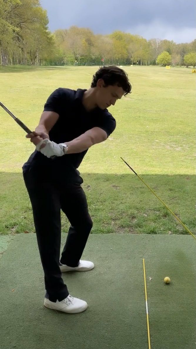 a man hitting a golf ball with a club