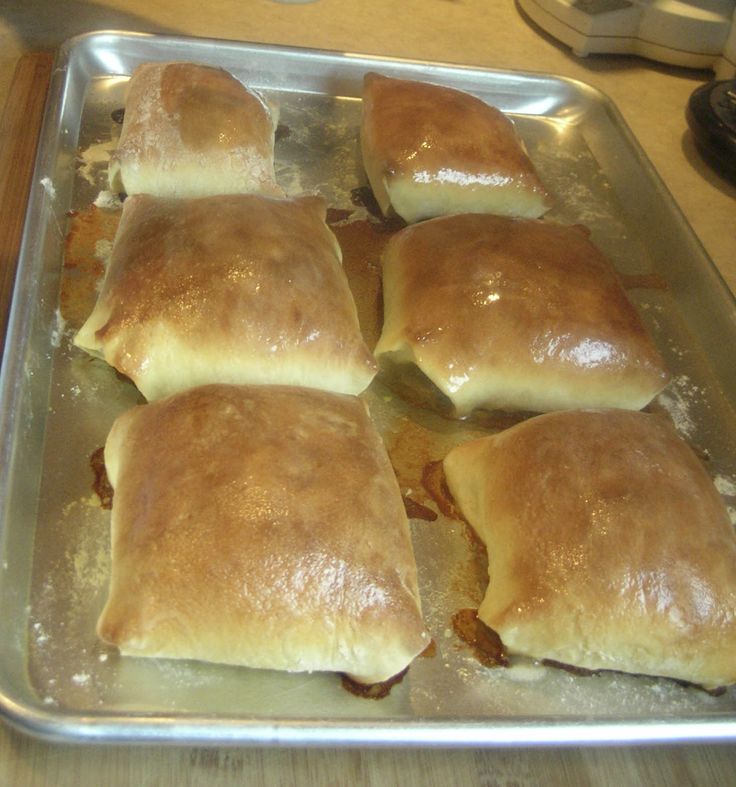 some bread rolls sitting on top of a metal pan