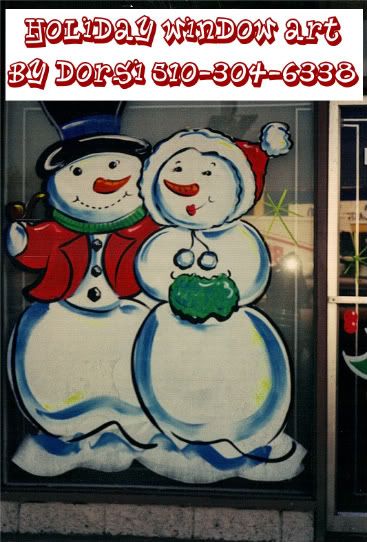 a couple of snowmen standing next to each other in front of a store window