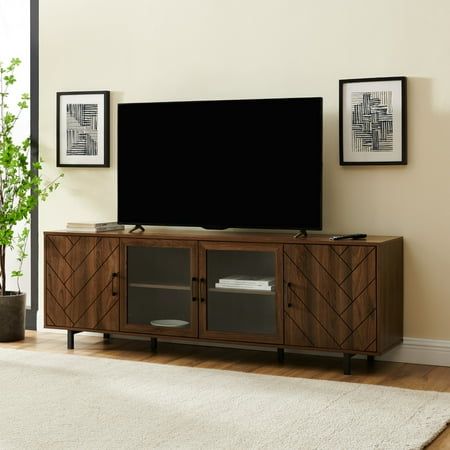 a flat screen tv sitting on top of a wooden entertainment center in a living room