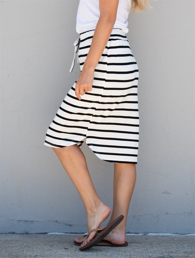 Hey there, fashion lovers! Get ready to add a new staple to your wardrobe with our Stripe Weekend Skirt in White Stripe. This skirt is perfect for any occasion, whether you want to dress it up or keep it casual. Made with super soft and lightweight fabric, this skirt is designed to provide comfort all day long. The knee-length and elastic waistband make it easy to wear for any body type. Plus, the white stripe pattern adds a touch of sophistication and elegance to your outfit. Pair it with a sim Versatile Midi Length Summer Bottoms, Versatile Midi-length Summer Bottoms, Trendy Summer Midi Bottoms, Trendy Summer Midi Length Bottoms, Trendy Cotton Midi Bottoms, Trendy Cotton Midi-length Bottoms, Trendy Midi Length Cotton Bottoms, Trendy Midi-length Cotton Bottoms, Cotton Midi Bottoms For Vacation