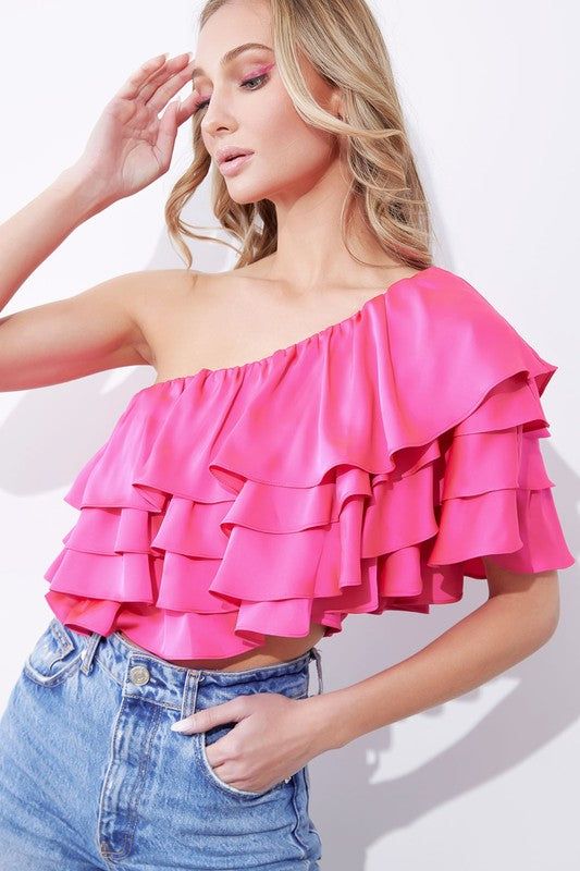 - Elasticized one shoulder ruffle tiered top- Fitted bodice with smocked back for stretch and comfort- Satin fabric - Pull-on styling - 100% polyester - Imported Pink Stretch One-shoulder Top, Pink One-shoulder Feminine Top, Feminine One Shoulder Top With Ruffles, Feminine Pink One-shoulder Top, Feminine One-shoulder Top With Ruffles, Pink Tiered Top For Summer, Summer Pink Tiered Tops, Chic One-shoulder Top With Ruffles, Strapless Ruffle Tops For Brunch