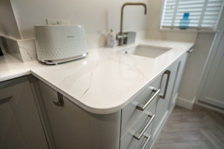 a kitchen counter with a toaster on top of it