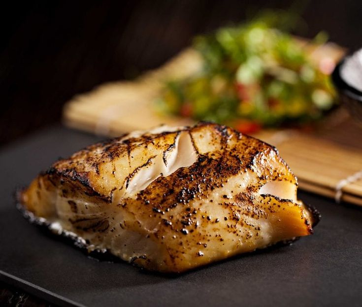 a piece of fish sitting on top of a cutting board