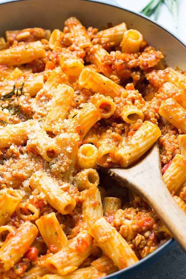 a skillet filled with pasta and meat sauce