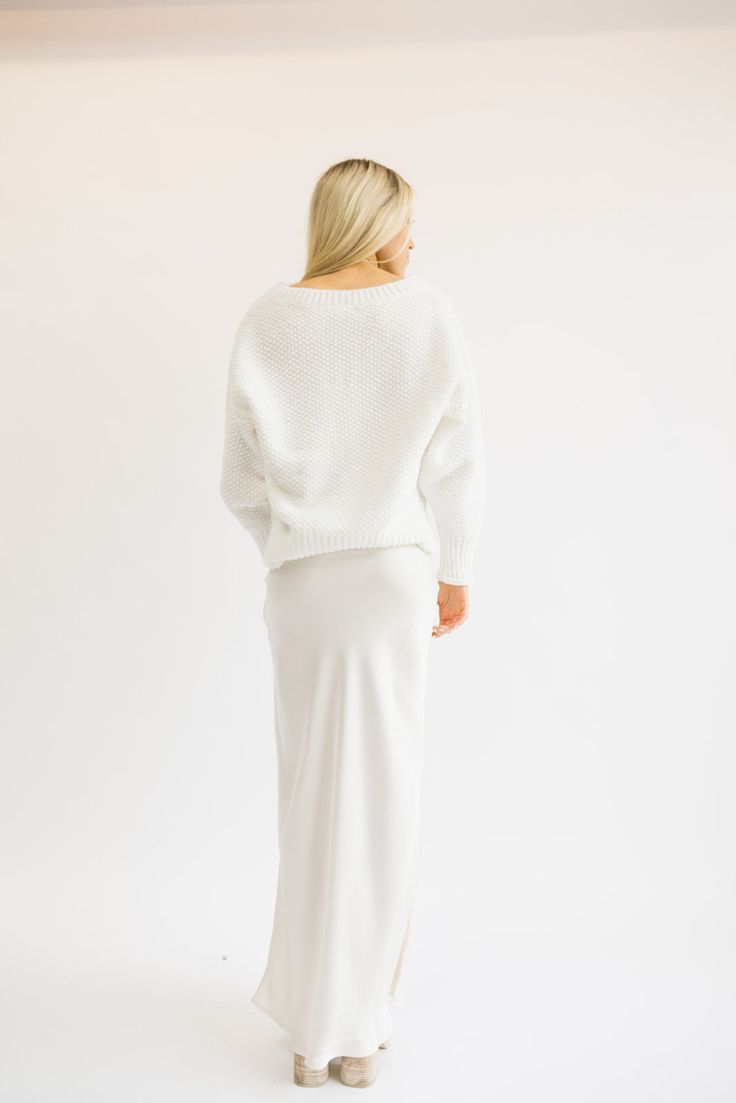 Just like its name - this sweater is SO SOFT. It feels so good on and is such a classic fit too! Everyone needs a white sweater like this one! Fits true to size being slightly oversized. Styled with our Ritzy Satin Midi Skirt. Model Info: Makena is 5’6 wearing size S/M. White Chunky Knit V-neck Sweater With Long Sleeves, White Long Sleeve V-neck Sweater With Ribbed Cuffs, Chic White Long Sleeve V-neck Sweater, Oversized White Soft Knit Sweater, White Oversized Cozy Sweater, Oversized White Soft Sweater, Oversized White Cozy Sweater, Oversized White Cropped Sweater For Layering, Cozy Soft Knit White Sweater