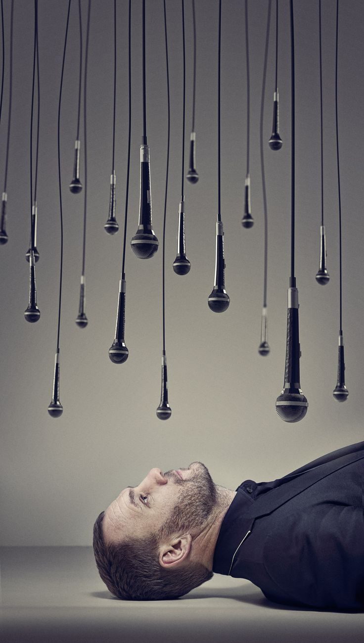 a man laying on the ground in front of a bunch of lights hanging from the ceiling