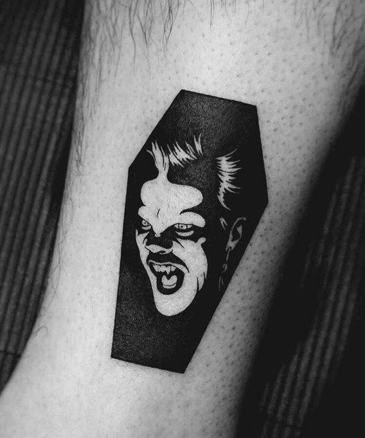 an evil clown tattoo on the arm