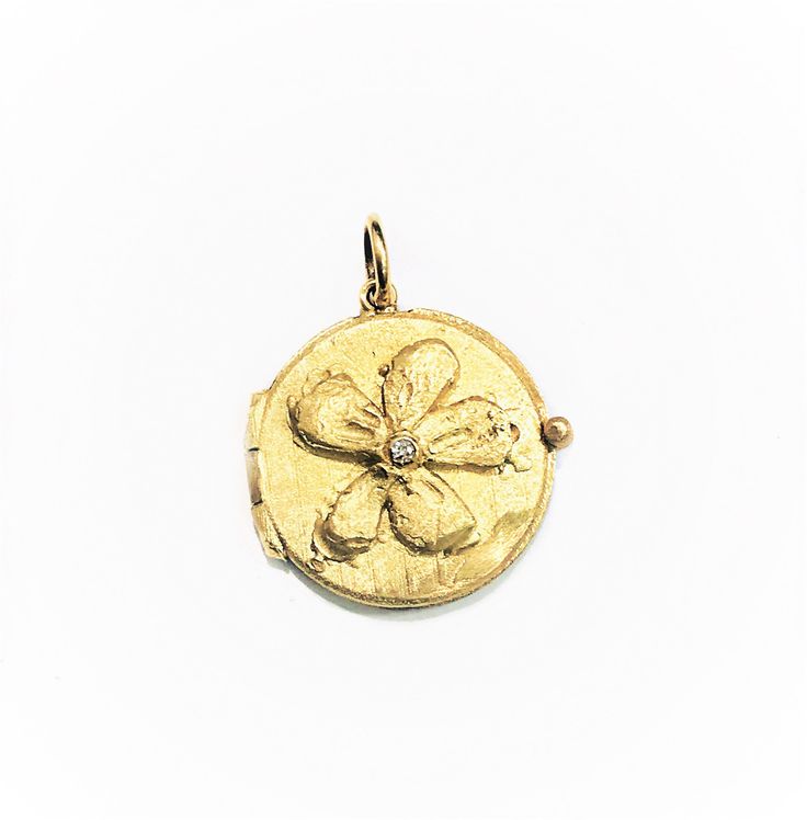 "This beautiful 14 Karat yellow gold \"Flower Locket\" pendant is embellished with a diamond of 0.02 ct. on the center and all handmade by Carolyn. Diamonds approx. 0.02 ct. weight Total weight of gold is 5 grams. Bale would accommodate approx. 1.5 - 2mm chain. Can be ordered in rose or white gold. 14K Yellow Gold 16\" long chain can be purchased separately for $80." Gold Angel Wings, Gold Locket, Evil Eye Charm, Gold Flower, Long Chain, Gold Flowers, Locket, Charm Pendant, Jewelry Necklace Pendant