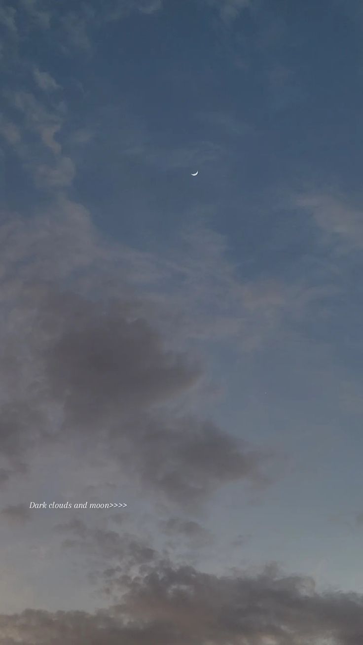 an airplane flying high in the sky with clouds above it and a moon behind it