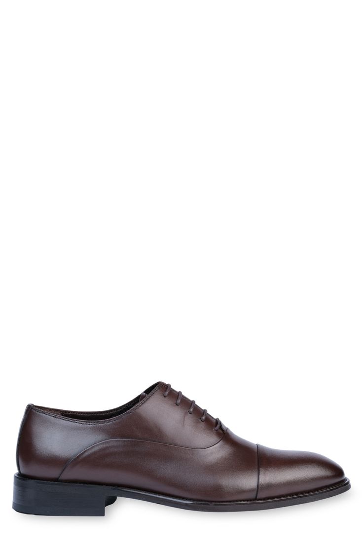 Handmade of smooth leather, this cap-toe dress shoe with a classic oxford silhouette offers a sophisticated, elegant look. Leather upper and lining/synthetic sole Made in Turkey Classic Oxford Lace-up Shoes With Rubber Heel Cap, Classic Oxford Lace-up Shoes For Business, Classic Cap Toe Oxfords For Semi-formal Occasions, Classic Semi-formal Oxford Lace-up Shoes, Classic Cap Toe Oxfords For Derby, Formal Oxford Cap Toe Derby Shoes, Formal Cap Toe Oxford Derby Shoes, Cap Toe Derby Shoes For Formal Occasions, Business Casual Cap Toe Derby