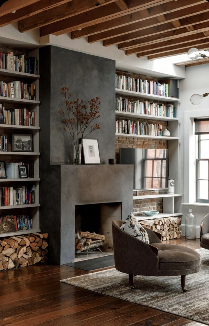 a living room filled with furniture and bookshelves next to a fire place in front of a fireplace