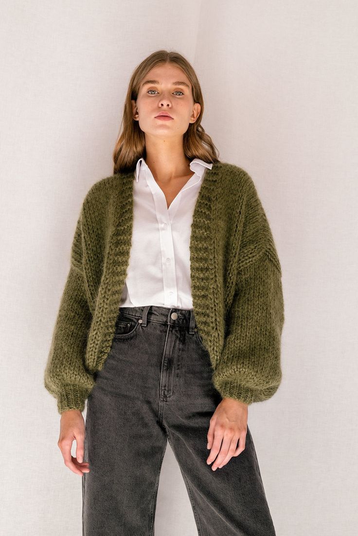 "The Mohair Bomber Cardigan -- hand knitted in fluffy kid mohair that feels like being wrapped in a soft, puffy cloud. Designed to flatter all silhouettes with its wide oversized fit, slightly cropped length and voluminous balloon sleeves. Comes in 8 versatile colors, carefully chosen to match all wardrobe color palettes. Handcrafted in Greece. DETAILS * Super soft, premium quality Italian mohair * Composition: 60% kid mohair, 40% microfiber * Hand wash in cold water SIZE & FIT * Wide fit, cropp Handmade Mohair Cozy Cardigan, Hand Knitted Mohair Cardigan, Hand Knitted Mohair Cardigan For Winter, Hand Knitted Mohair Outerwear, Green Mohair Winter Cardigan, Cozy Mohair Knitted Cardigan, Cozy Knitted Mohair Cardigan, Cozy Hand Knitted Mohair Cardigan, Cozy Fall Mohair Knitting Pattern