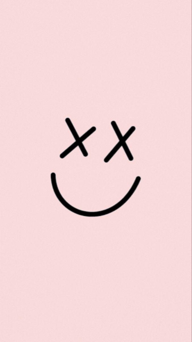 a pink background with a smiley face drawn on the bottom and two crosses in the middle