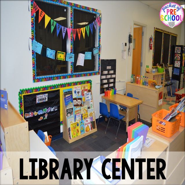 the library center is full of children's desks and chairs with colorful flags on them