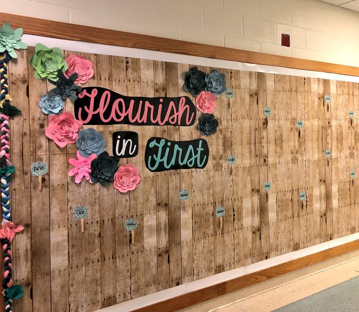 a wooden wall with flowers on it and the words sequish in first written on it